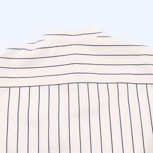 Detail of loose striped shirt showing horizontal and vertical patterns on fabric