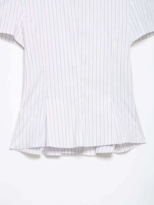 Detail of blue striped poplin shirt showing pleated hem and premium cotton fabric texture