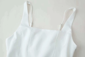 Detail showing white strapless top with square neck and visible vertical stitching seams
