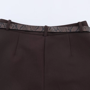 Close-up of brown casual pants featuring a stylish snakeskin texture belt and belt loops