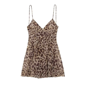 Close-up of leopard print fabric and V-neck detail on a summer strappy dress