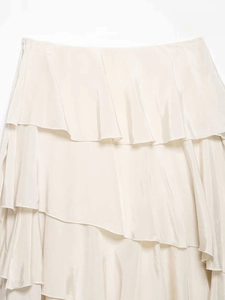Detail of elegant ivory satin skirt with tiered ruffles and smooth silk texture