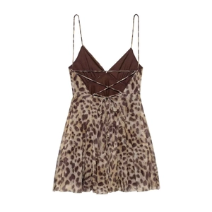 Detail view of leopard print summer dress featuring a backless design with cross-straps