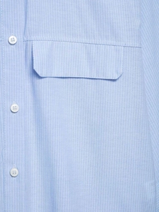 Close-up of a striped blue casual shirt featuring a front pocket and white button details