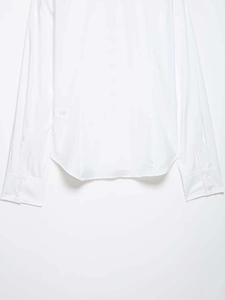 Detail of white long sleeve shirt showing classic button cuffs and curved shirt hem