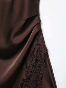 Detail of coffee brown satin dress with lace trim and elegant gathered pleats