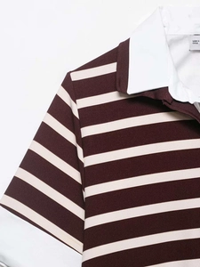 Detail of white polo collar and burgundy striped knit fabric texture with neck label