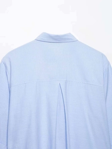 Detail of light blue striped shirt back showing the yoke and central box pleat design