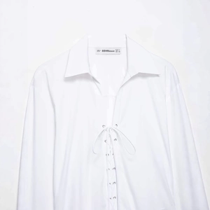 Relaxed white long sleeve shirt with front lace-up detail and metal eyelets for women