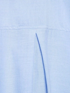 Detail of light blue striped fabric showing back yoke and pleated craftsmanship on shirt