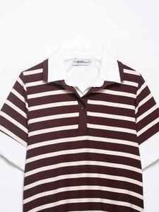 Close-up detail of burgundy striped polo shirt featuring white collar and brand neck label