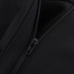 Close-up of the smooth black metal zipper and textured fabric of casual high-waist shorts