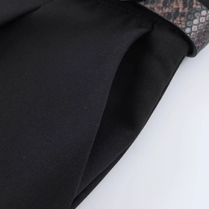 Detailed view of women's black casual shorts with side pocket and snakeskin belt texture