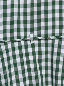 Detail of green and white gingham fabric with waist seam and stitching on shirt dress