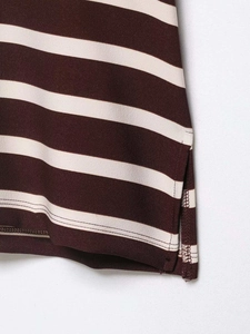 Detail view of burgundy and beige striped polo shirt featuring a side slit hem and stitching