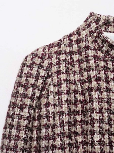 Detailed close-up of premium tweed fabric in burgundy and beige for women short jacket