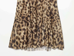 Close-up of leopard print layered dress hem showing sheer fabric and pleated texture