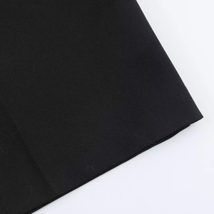 Close-up detail of premium black woven fabric and high-quality edge stitching of the shorts