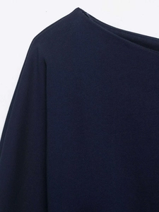 Close-up of navy blue off-shoulder knit sweatshirt with vertical textured fabric