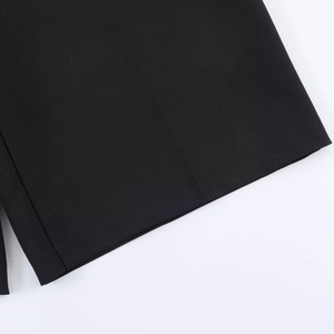Detailed close-up of high-quality black woven fabric and neat stitching on casual shorts