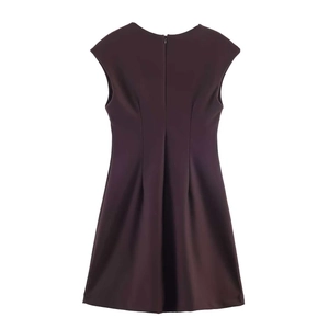 Detailed view of the invisible back zipper and fine waist pleats on this dark purple dress
