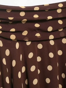Close-up of lightweight brown chiffon fabric with large cream polka dot print detail