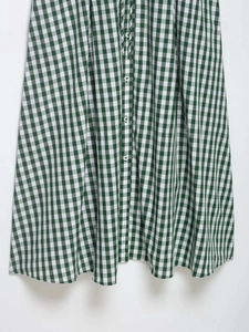 Detail of green and white gingham summer shirt dress with vertical button closure