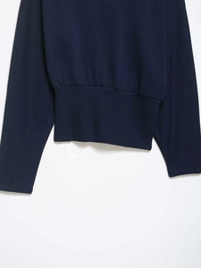 Detailed view of the dark navy cotton sweatshirt featuring wide ribbed hem and slim fit cut