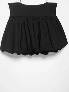 Detail of a chic black bubble hem camisole top featuring thin straps and pleated volume