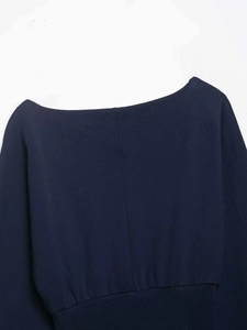Detail of navy blue off-shoulder sweatshirt showing ribbed hem and knit texture