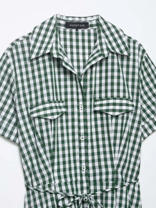 Detailed view of the green and white plaid shirt dress with collar and waist tie belt