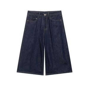 Flat lay of retro dark blue high-waisted denim wide-leg shorts with A-line silhouette