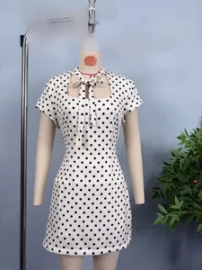 Detail of French chic polka dot short dress showing bow-tie neck and cutout design
