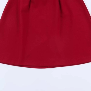 Detailed close-up of the double-needle stitched hem on a red A-line summer dress
