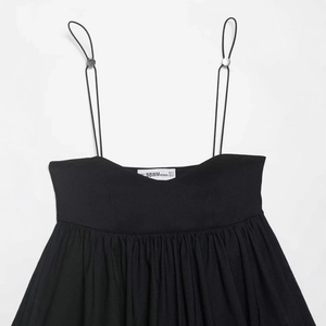 Black spaghetti strap top with silver adjustment buckles and pleated texture detail