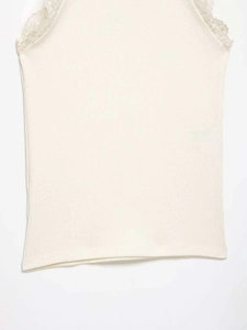 Detailed view of off-white ribbed knit vest with delicate lace trim on the collar and edge