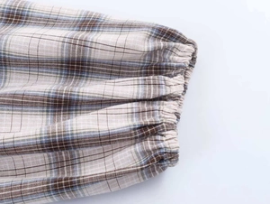 Detail of elasticated cuff on vintage plaid cotton blouse with blue and brown patterns