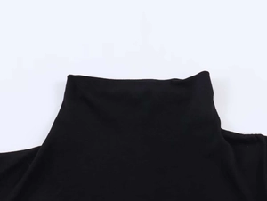 Detailed close-up of the black high-neck collar and stitching on the dress fabric