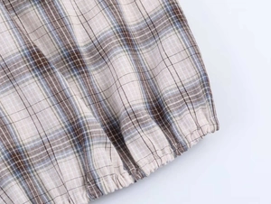 Detail shot of vintage checkered fabric with elastic cuff and textured weave patterns