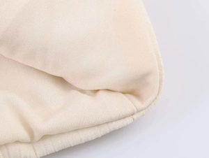 Close-up of off-white lace tank top showing rib knit edges and soft fleece lining texture