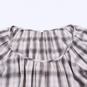 Women's plaid puff sleeve shirt with blue and white check pattern and ruffled neckline