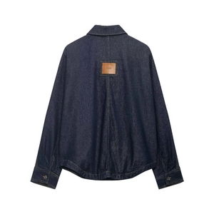 Dark blue denim jacket back view with leather brand patch on plain white background