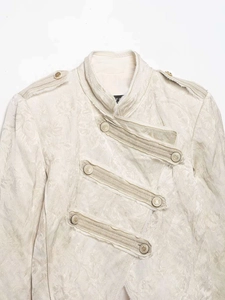 Close-up of floral jacquard texture with stand collar and military shoulder tabs
