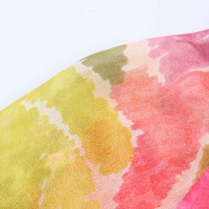 Detailed macro view of lightweight floral print fabric with vibrant watercolor patterns