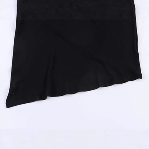 Asymmetric pleated black dress with irregular hemline in a contemporary minimalist style