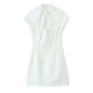 Close-up of white mini dress with halter neck, bow tie detail, and hollow-out chest cut