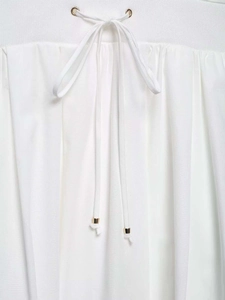 Detail of white shirt dress elastic waist with drawstring and gold metal tips