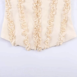 Sleeveless cream lace tank top featuring vertical ruffle trim and delicate lace-up details
