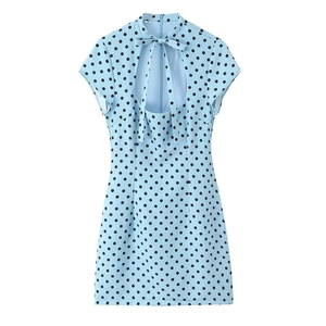 Detail of light blue polka dot mini dress featuring a bow tie collar and size M label