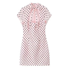 Detailed back view of pink polka dot mini dress with teardrop cutout and elegant bow tie